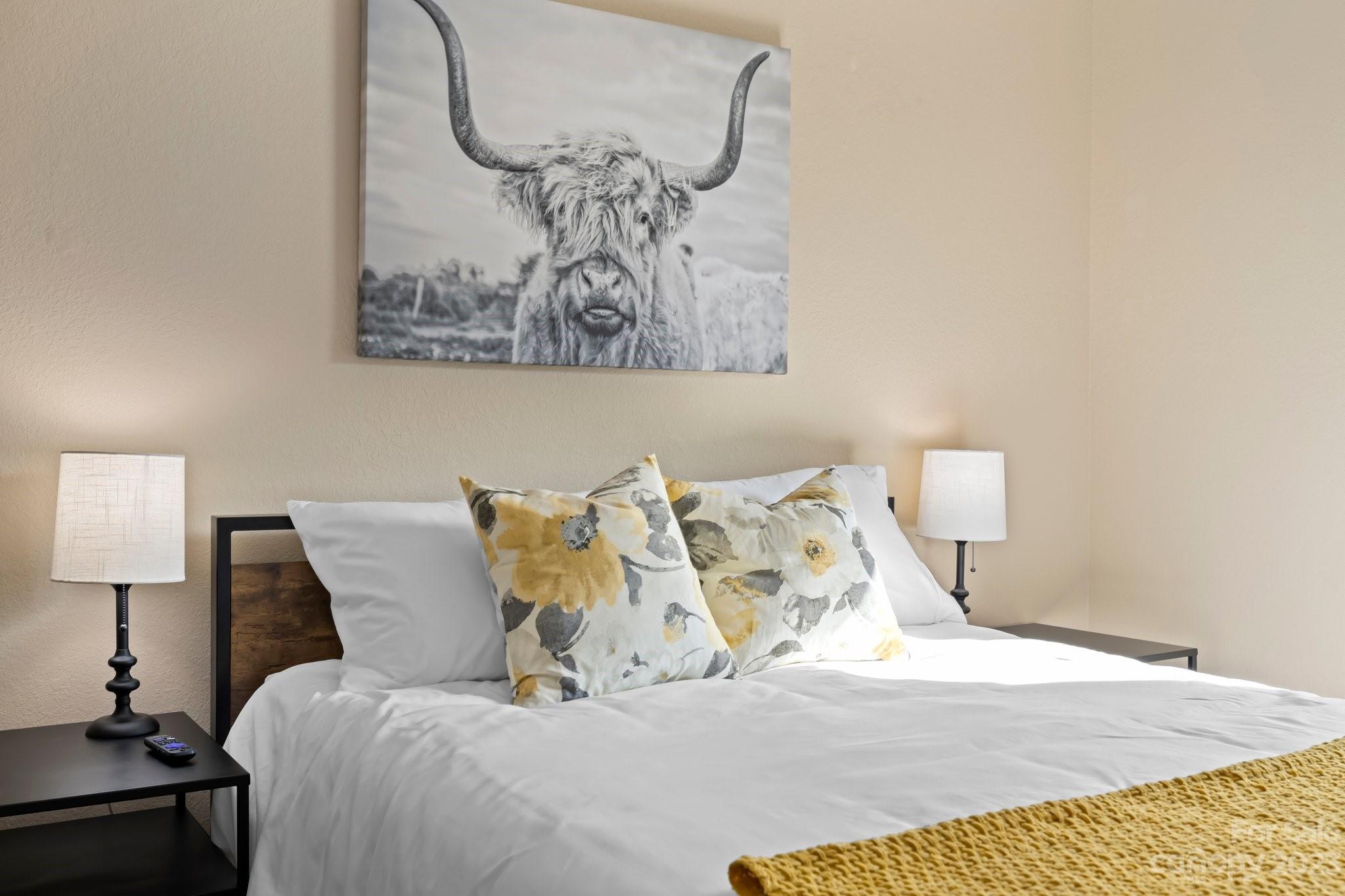 174 Diamond Point Canton, NC 28716 - Photo 22 of 43 a bed with a white comforter and pillows