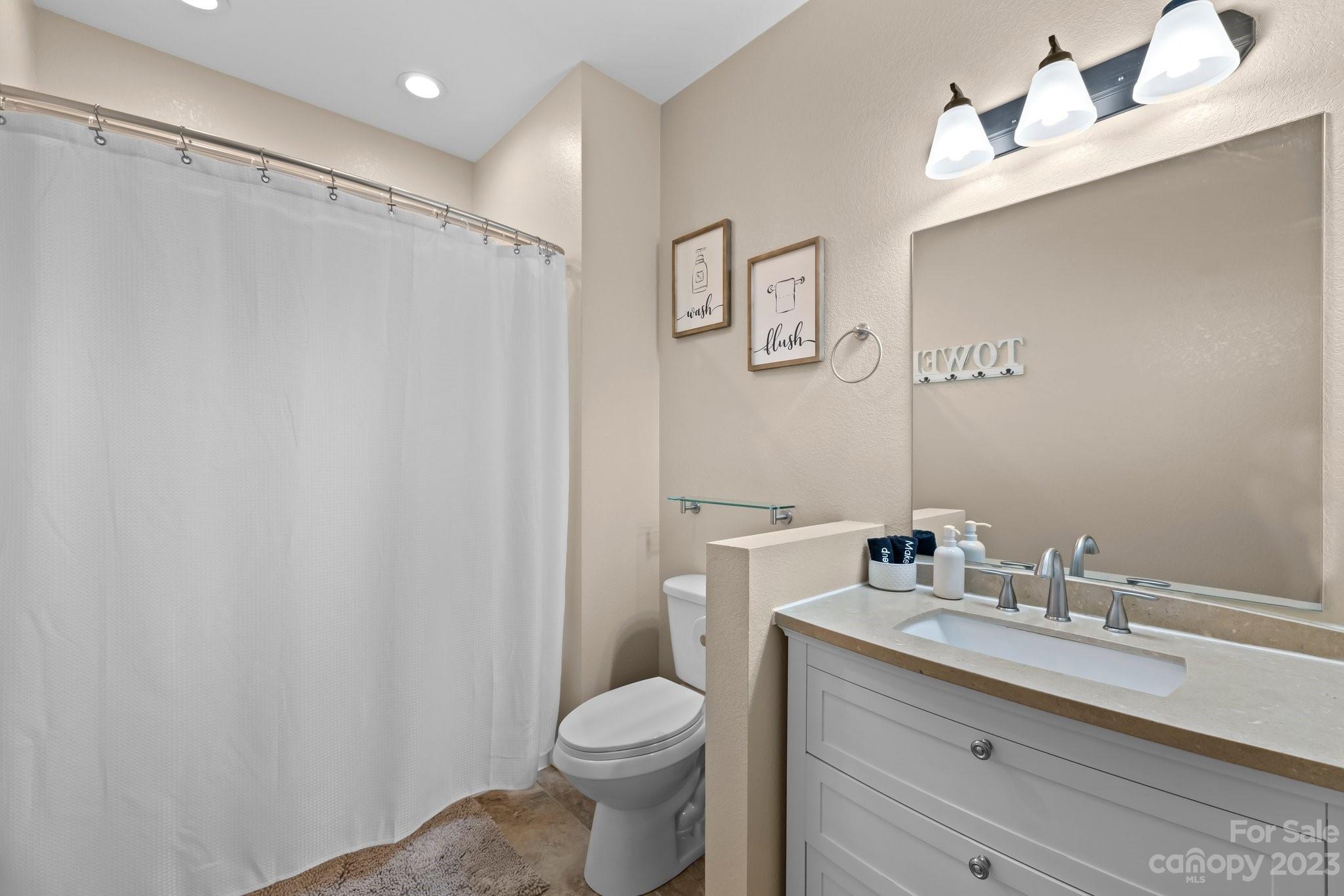 174 Diamond Point Canton, NC 28716 - Photo 24 of 43 a bathroom with a granite countertop sink toilet and shower