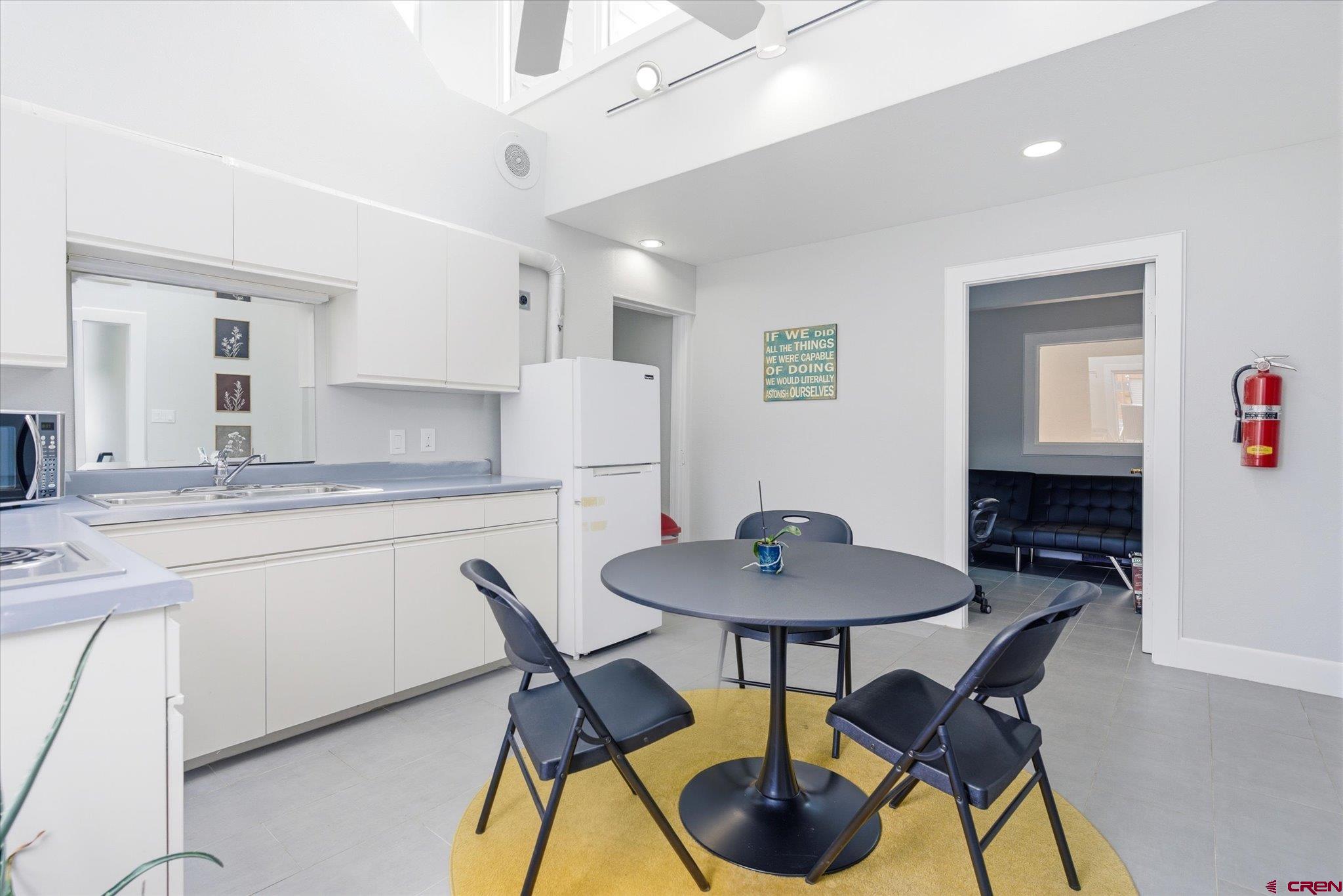 2901 Main Avenue Durango, CO 81301 - Photo 16 of 24 a kitchen with stainless steel appliances granite countertop a dining table chairs and a refrigerator