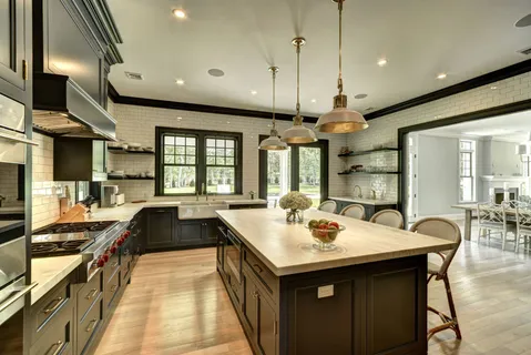 a kitchen with stainless steel appliances granite countertop a sink a stove and a refrigerator