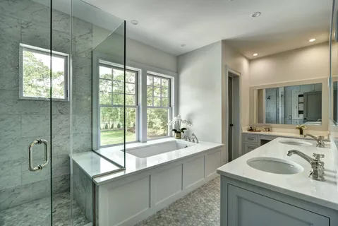 a bathroom with a sink and mirror with bathtub