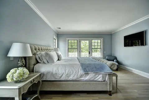 a bedroom with a bed window and a lamp