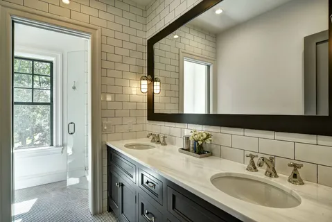 a bathroom with a double vanity sink and a mirror
