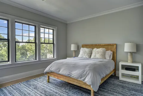 a bedroom with a bed and a night stand