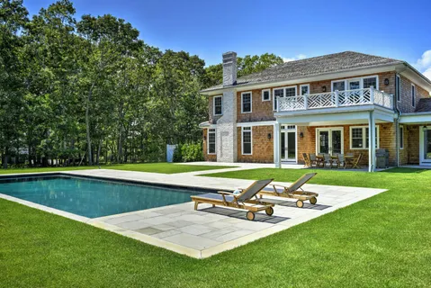 a view of a house with swimming pool and sitting area