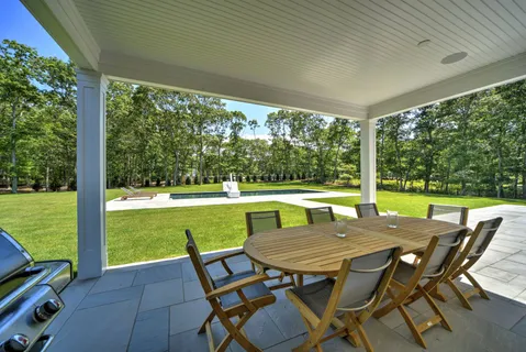 a view of an outdoor dining space with a table and chairs