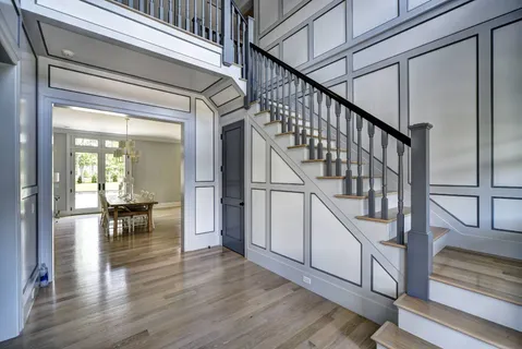 a view of entryway and hall with wooden floor