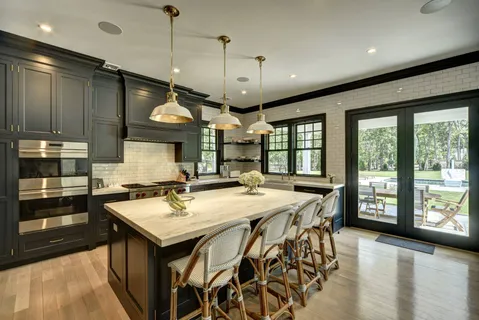 a kitchen with stainless steel appliances granite countertop a stove a sink dishwasher and a refrigerator with wooden floor