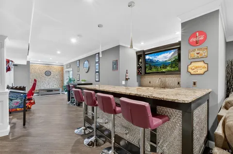 a view of kitchen with stainless steel appliances dining table and chairs