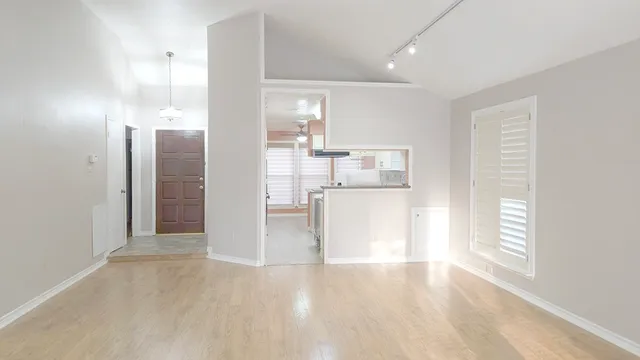 a view of a kitchen with wooden floor and a kitchen