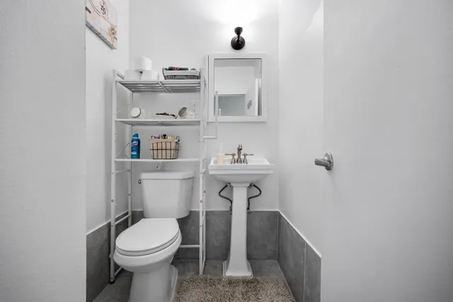 a bathroom with a sink toilet and vanity