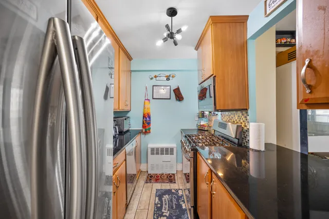 a kitchen with stainless steel appliances granite countertop a stove and a microwave