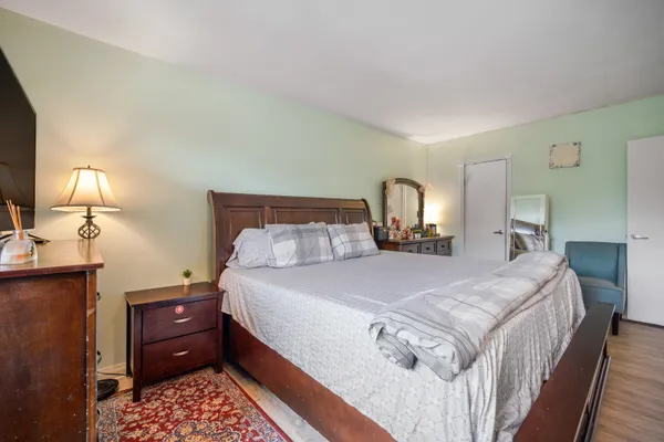 a bed room with a bed and a mirror