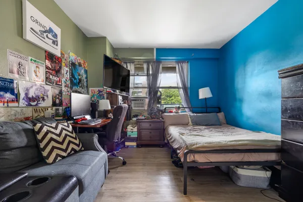 a bedroom with a bed and a lamp