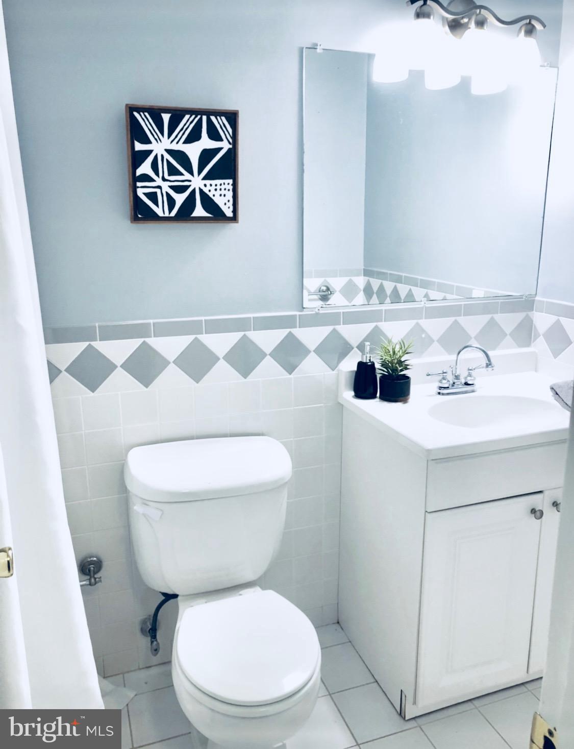 35 Hyacinth Road Baltimore, MD 21234 - Photo 14 of 23 a white toilet sitting next to a bathroom sink