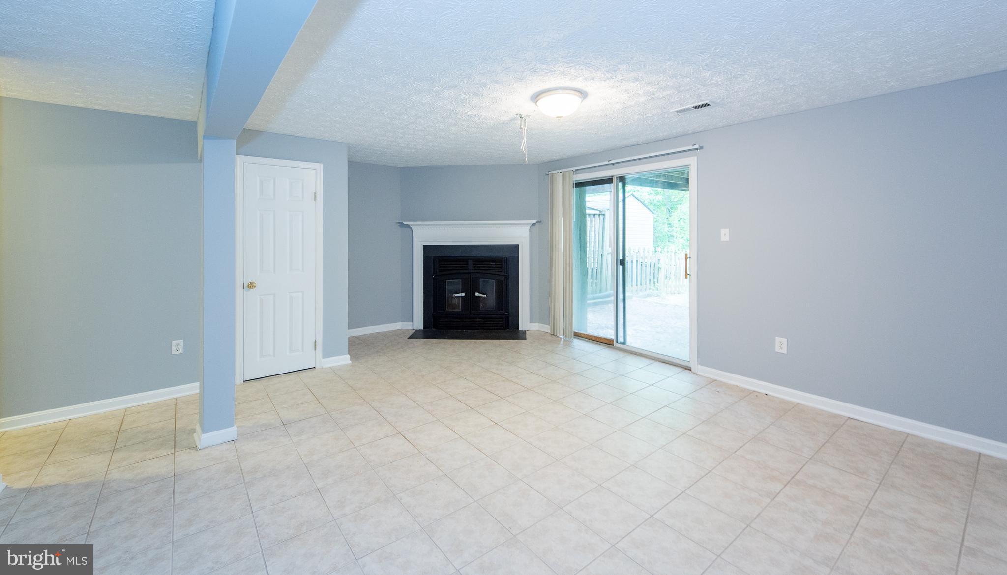 35 Hyacinth Road Baltimore, MD 21234 - Photo 16 of 23 an empty room with fireplace and windows