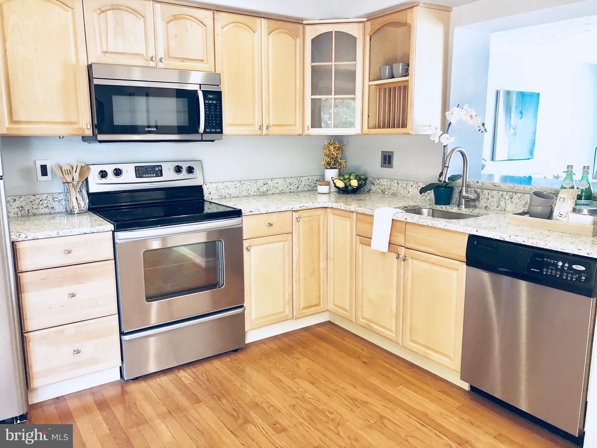35 Hyacinth Road Baltimore, MD 21234 - Photo 5 of 23 a kitchen with granite countertop wooden cabinets stainless steel appliances and a window