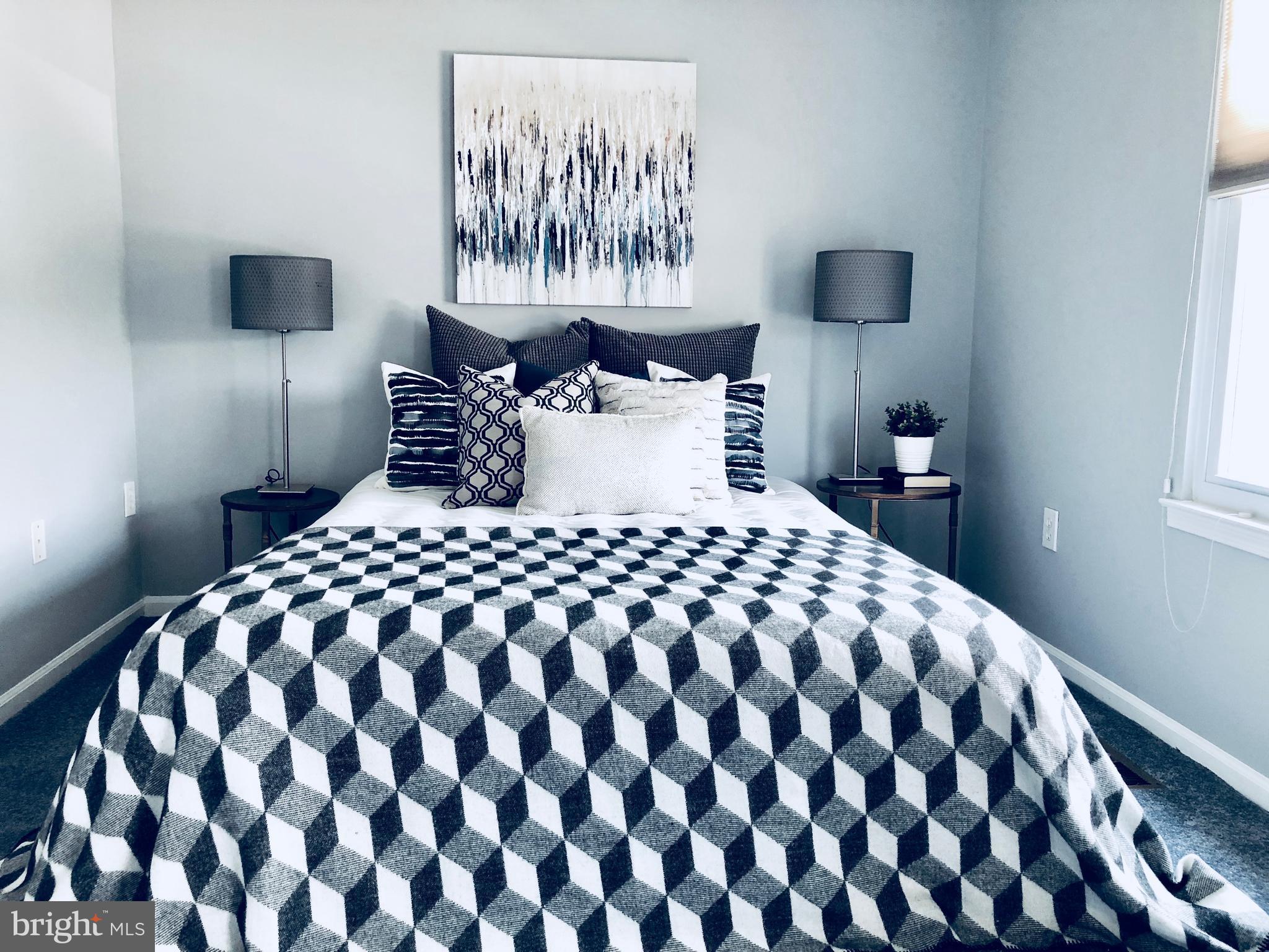 35 Hyacinth Road Baltimore, MD 21234 - Photo 8 of 23 a large bed with a black and white comforter