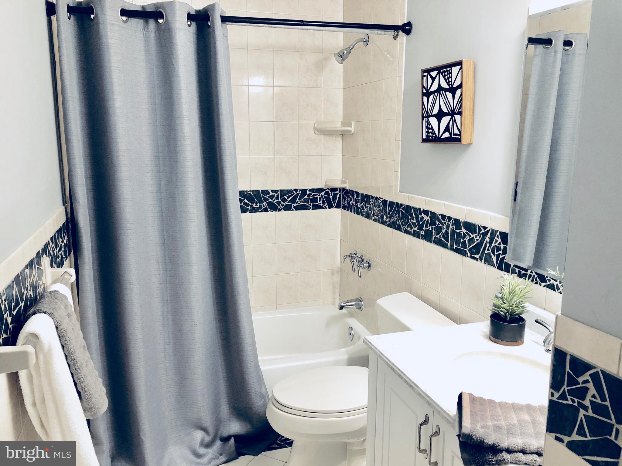 35 Hyacinth Road Baltimore, MD 21234 - Photo 9 of 23 a bathroom with a shower a toilet and a sink