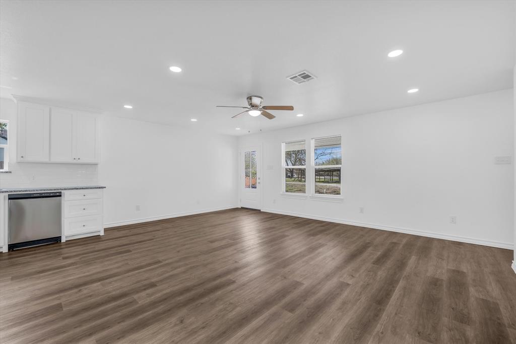 204 North Wiebusch Street Riesel, TX 76682 - Photo 7 of 33 an empty room with wooden floor and windows