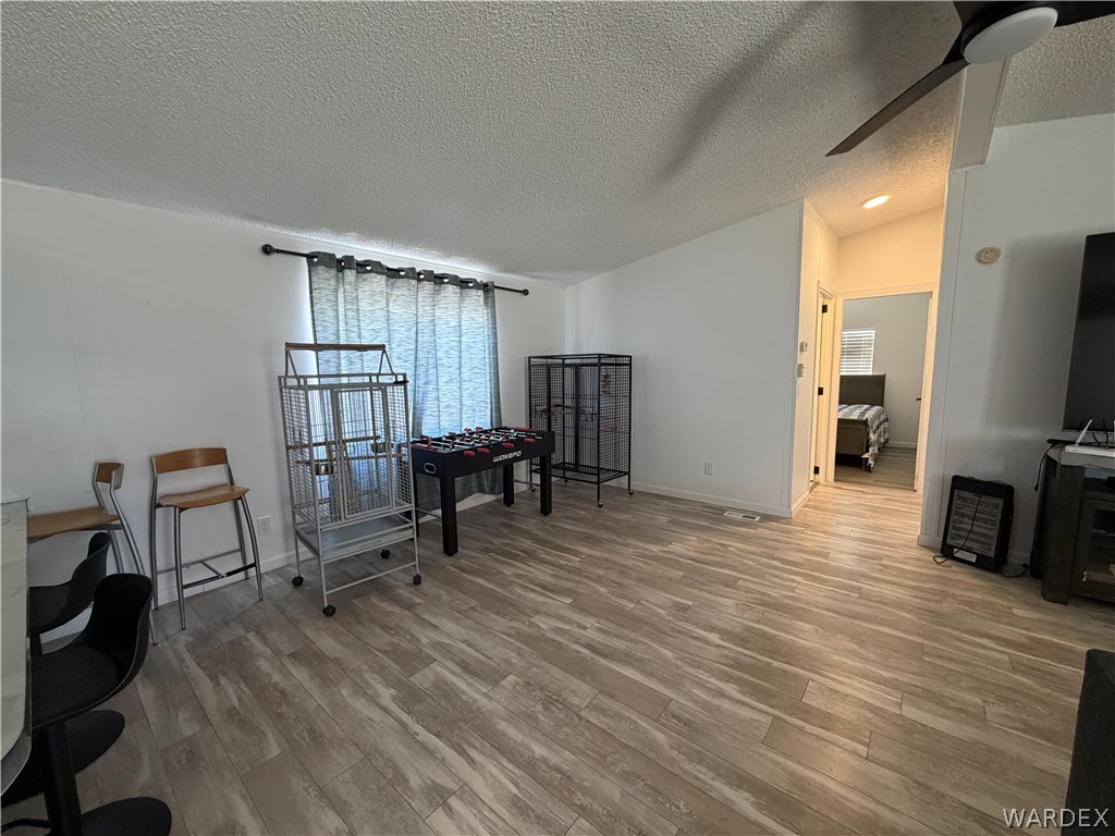 1910 Rio Grande Road Bullhead City, AZ 86442 - Photo 9 of 29 Spacious interior featuring wood-finish flooring, white walls, and a recessed doorway