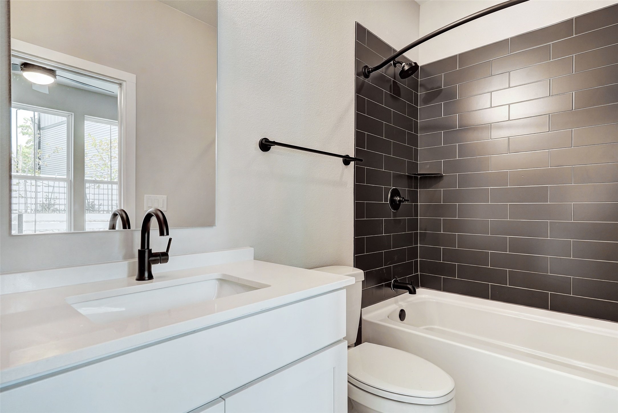 3809 Valley View Road, Unit 13 Austin, TX 78704 - Photo 7 of 27 a bathroom with a sink a toilet and shower