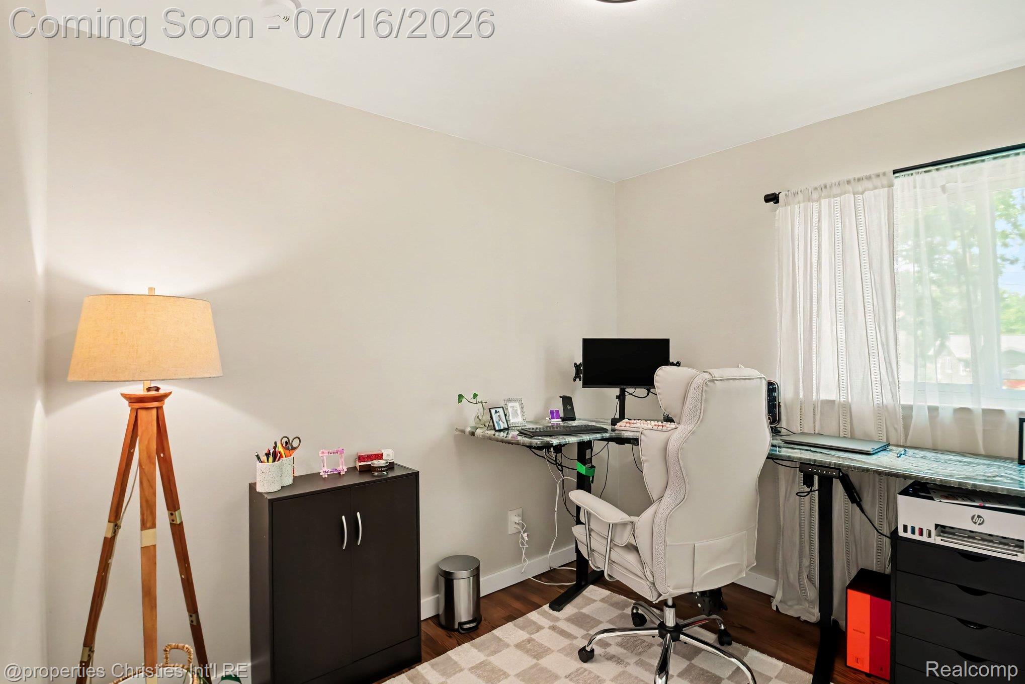 3304 Riverside Drive Port Huron, MI 48060 - Photo 18 of 26 Room featuring a window with sheer white curtains, light-colored walls, and wood-finish flooring
