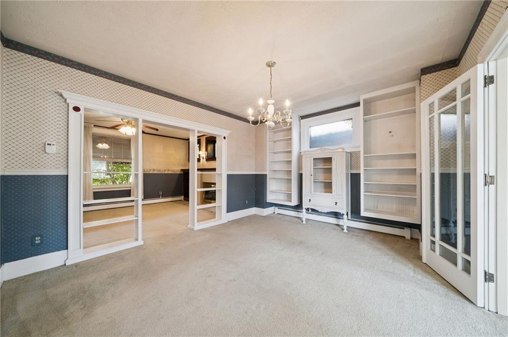 100 Grace Street Apollo, PA 15613 - Photo 14 of 42 an empty room with a fireplace and cabinet