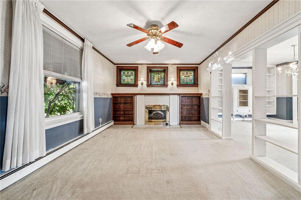 100 Grace Street Apollo, PA 15613 - Photo 10 of 42 an empty room with fireplace chandelier and windows