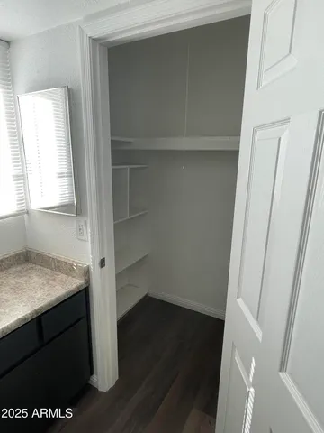 a view of walk in closet with empty racks