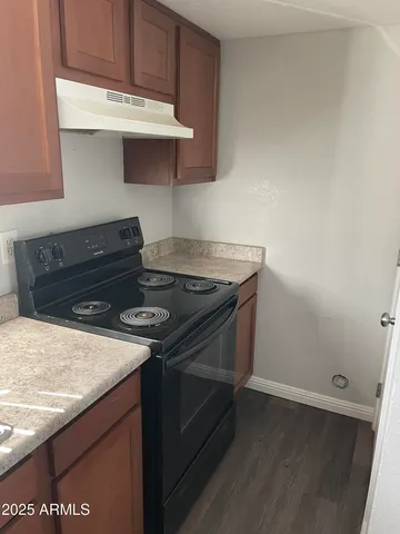 a kitchen with granite countertop a stove and a sink
