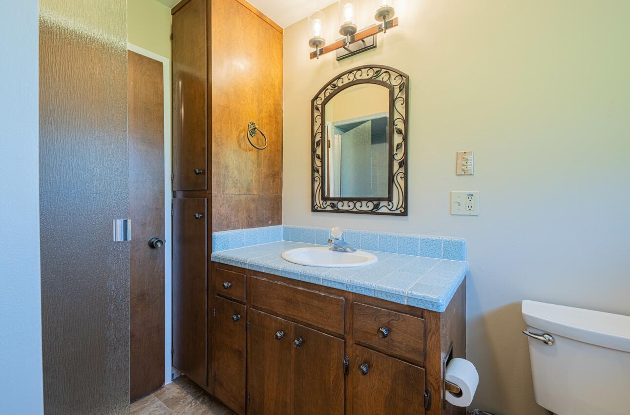 52259 Pine Canyon Road King City, CA 93930 - Photo 42 of 62 a bathroom with a toilet sink and mirror