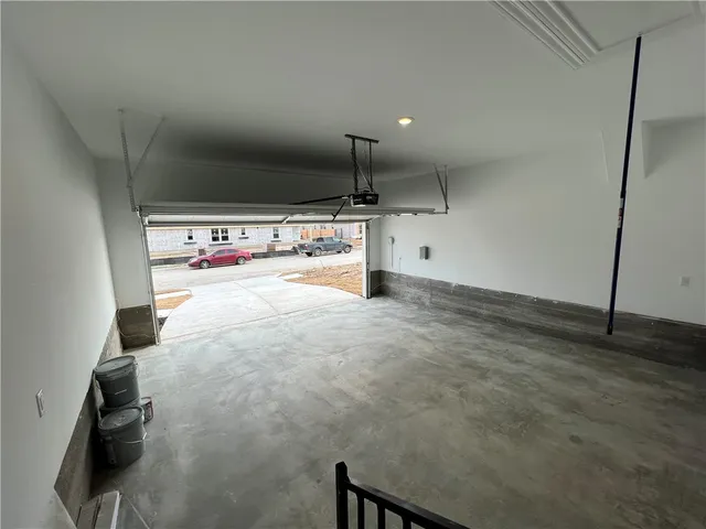 a view of a kitchen with a sink and dishwasher with wooden floor