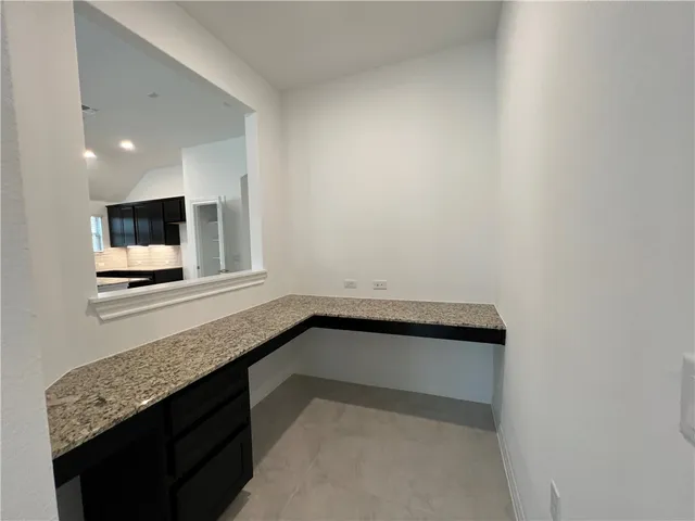 a bathroom with a tub a double vanity sink and mirror