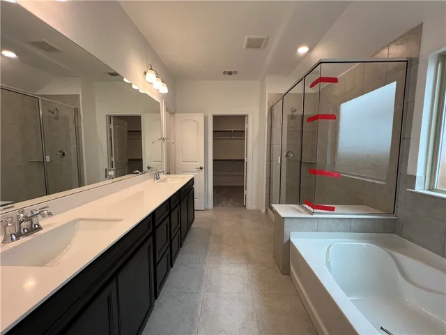 a bathroom with a double vanity sink mirror and shower