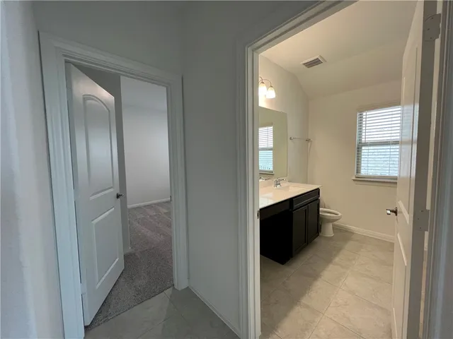 a spacious bathroom with a bathtub and a sink