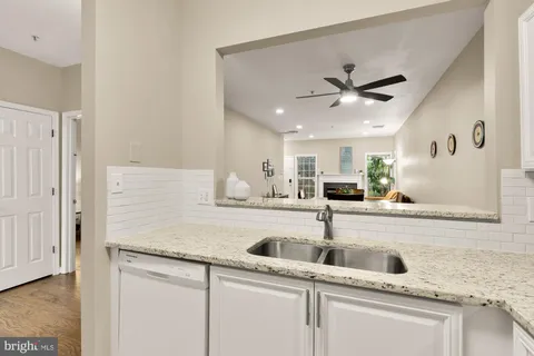 a kitchen with a sink a counter top space and cabinets