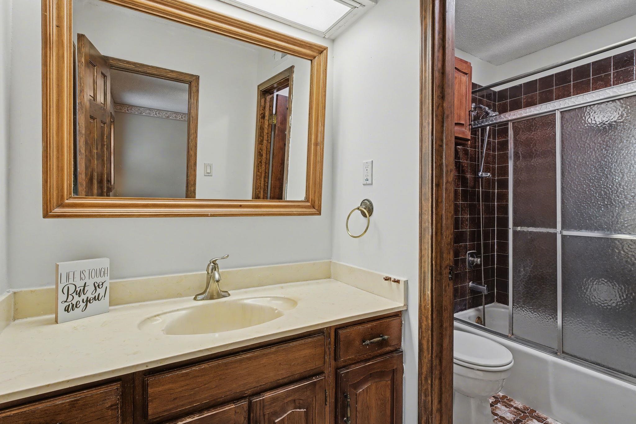 11380 Sycamore Farms Road Collierville, TN 38017 - Photo 24 of 35 Bathroom featuring vanity, enclosed tub / shower combo, and a textured ceiling