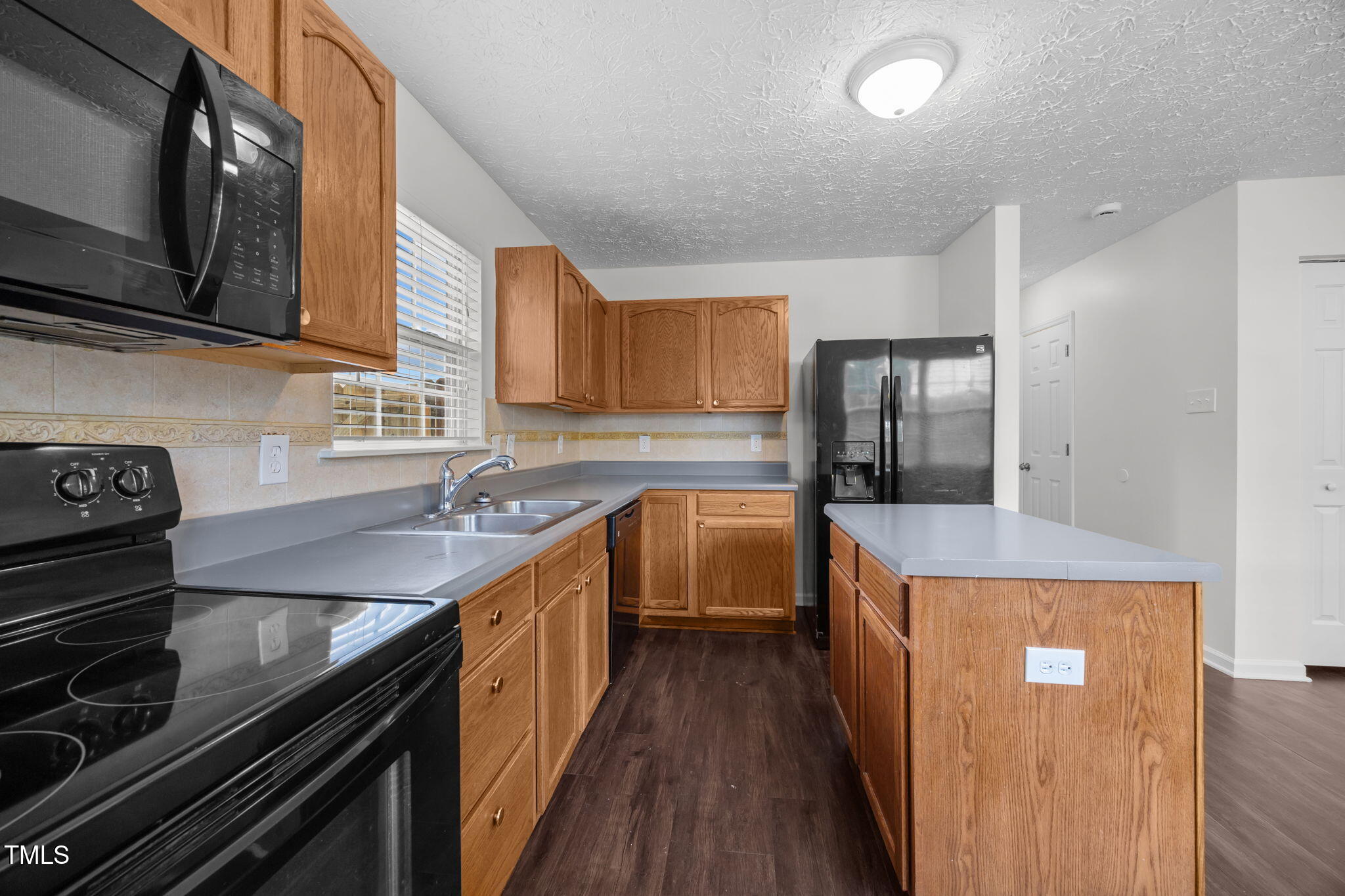 4232 Palafox Court Raleigh, NC 27604 - Photo 12 of 42 a kitchen with stainless steel appliances granite countertop a stove a sink and a refrigerator