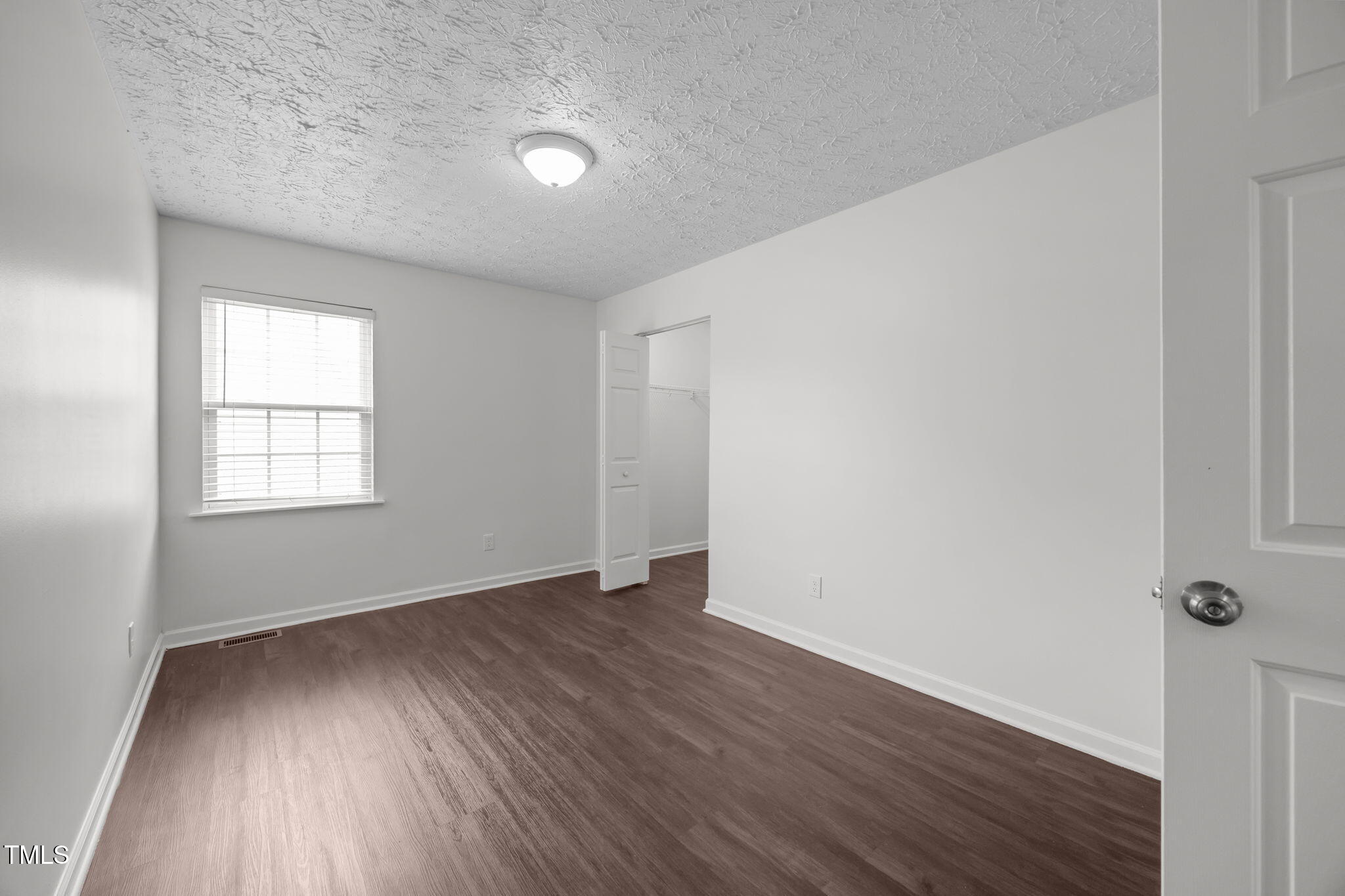 4232 Palafox Court Raleigh, NC 27604 - Photo 15 of 42 an empty room with wooden floor and windows
