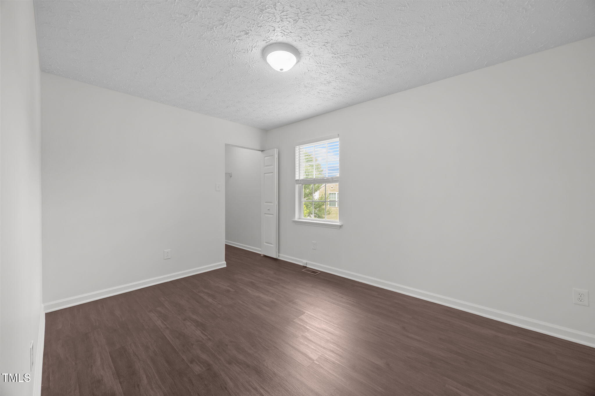 4232 Palafox Court Raleigh, NC 27604 - Photo 18 of 42 an empty room with wooden floor and windows