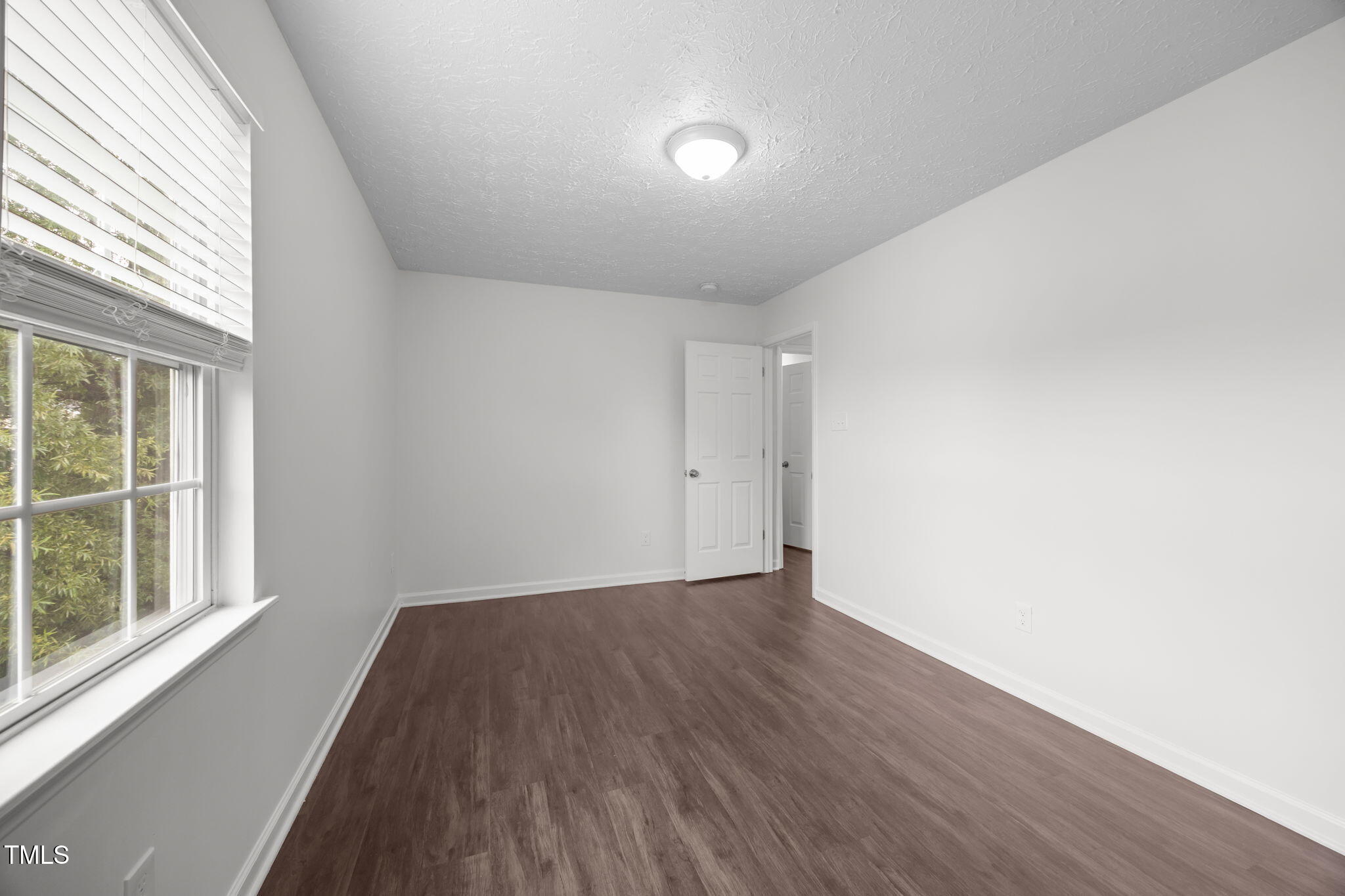 4232 Palafox Court Raleigh, NC 27604 - Photo 20 of 42 an empty room with wooden floor and windows
