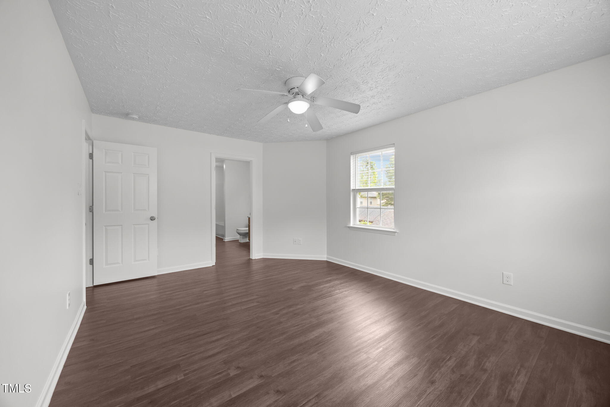 4232 Palafox Court Raleigh, NC 27604 - Photo 22 of 42 a view of an empty room with wooden floor and a ceiling fan