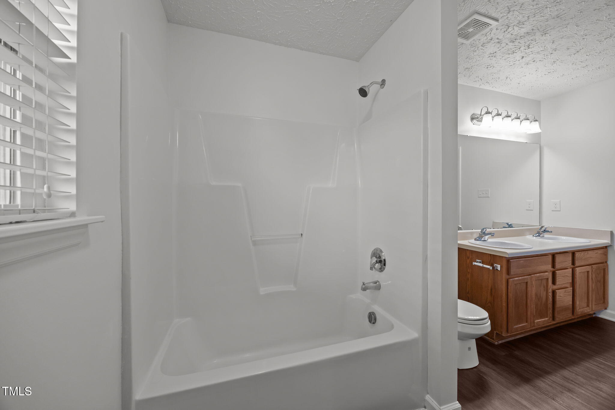 4232 Palafox Court Raleigh, NC 27604 - Photo 24 of 42 a bathroom with a tub sink vanity granite and toilet