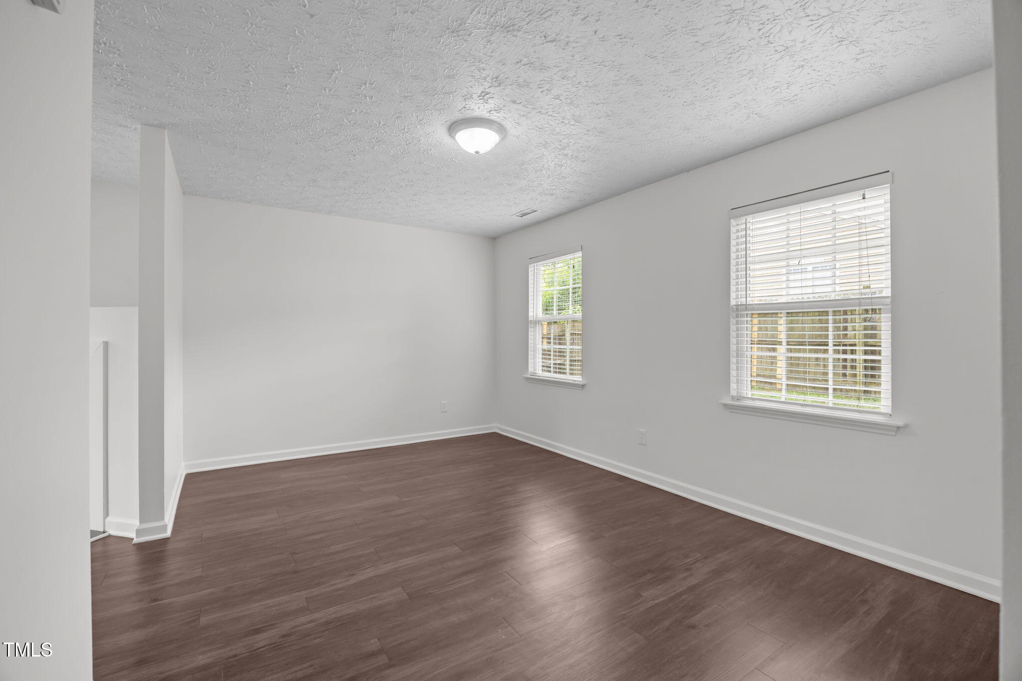 4232 Palafox Court Raleigh, NC 27604 - Photo 4 of 42 an empty room with wooden floor and windows