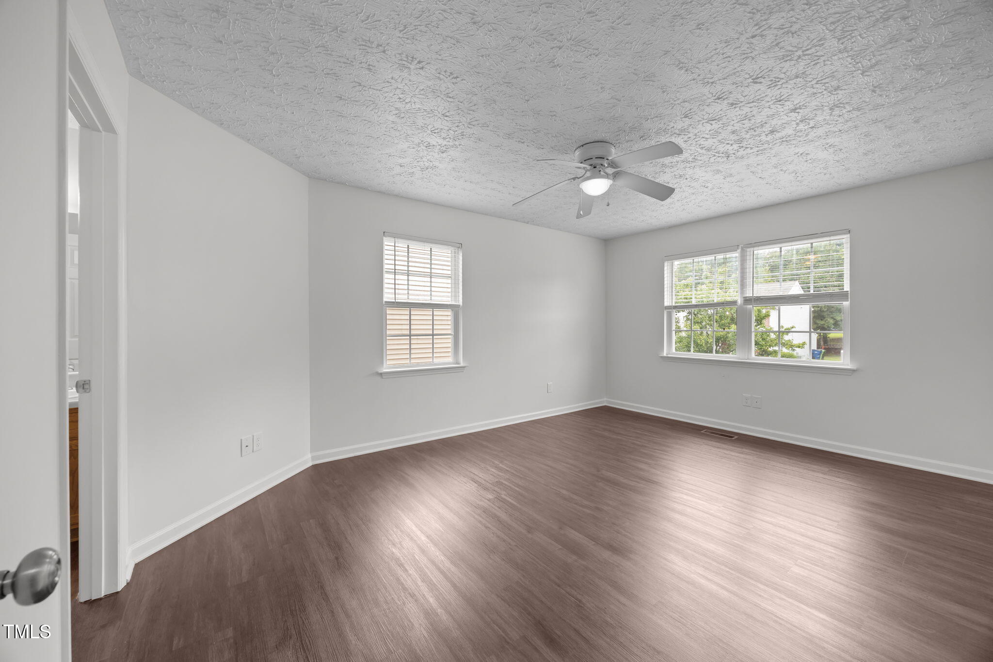 4232 Palafox Court Raleigh, NC 27604 - Photo 5 of 42 an empty room with wooden floor chandelier fan and windows