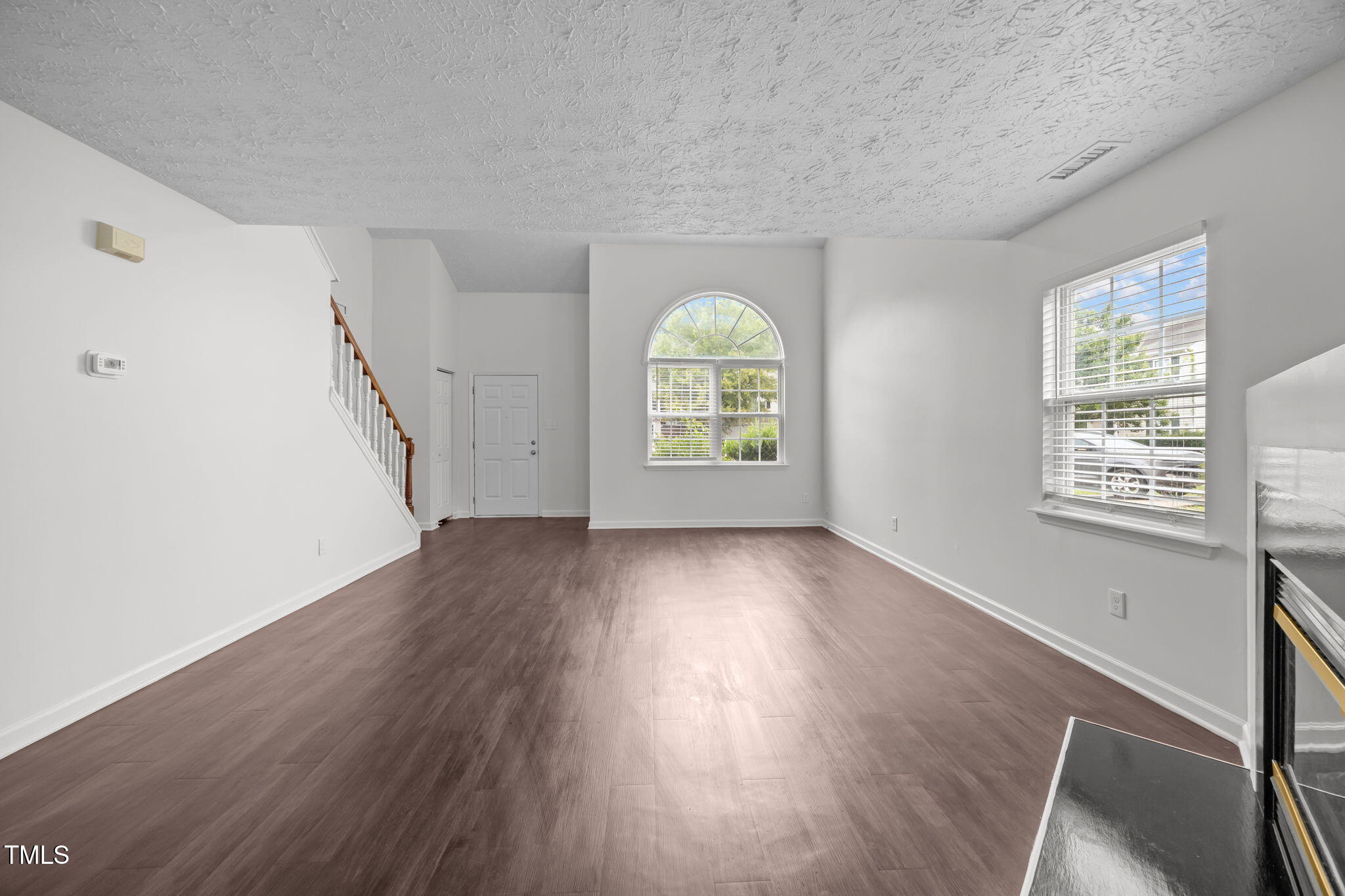 4232 Palafox Court Raleigh, NC 27604 - Photo 8 of 42 a view of an empty room with wooden floor and a window