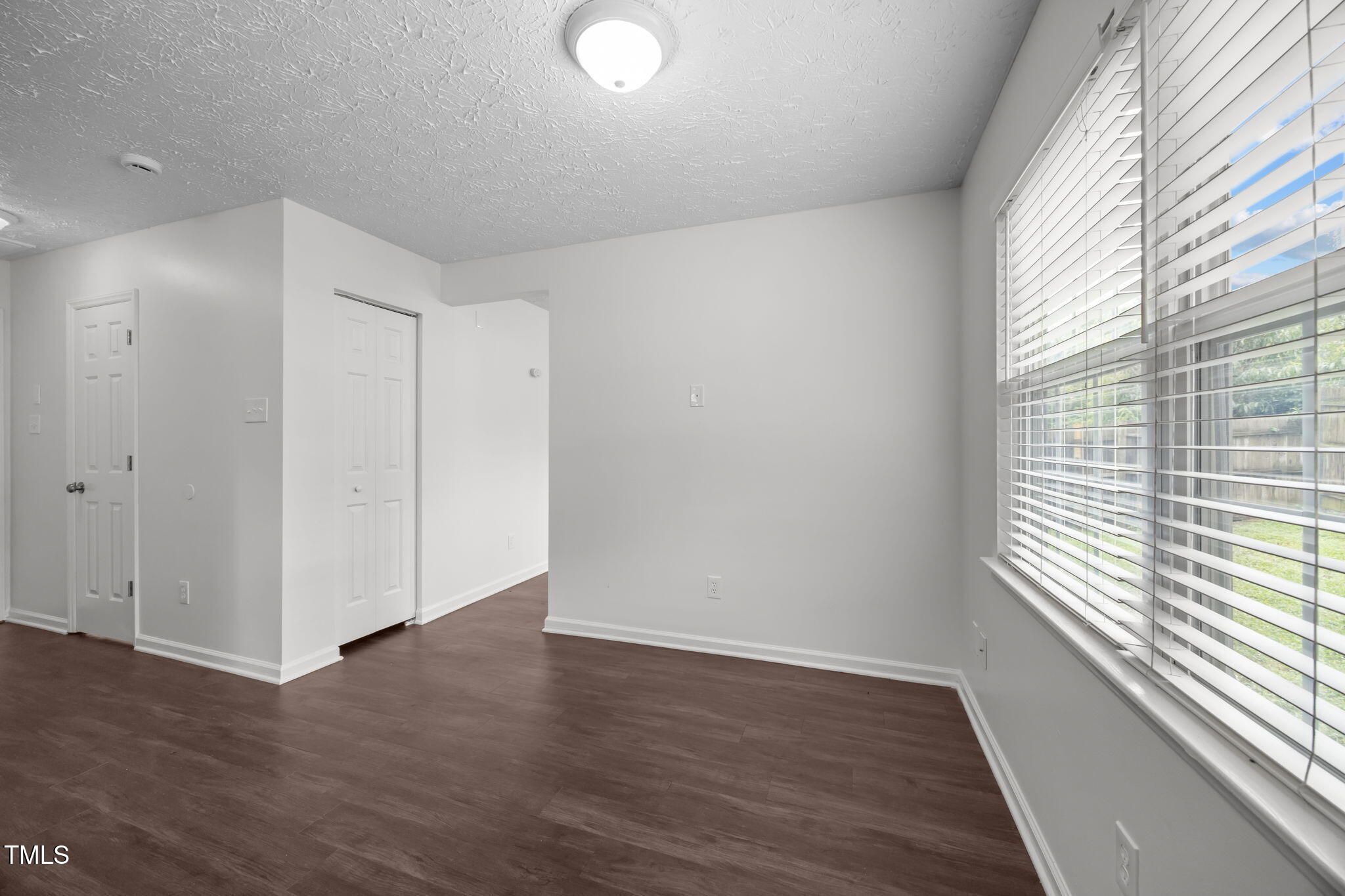 4232 Palafox Court Raleigh, NC 27604 - Photo 10 of 42 a view of an empty room with wooden floor and a window