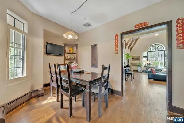 a view of a dining room with furniture window and wooden floor