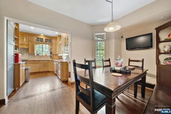 a view of a dining room with furniture large windows and wooden floor